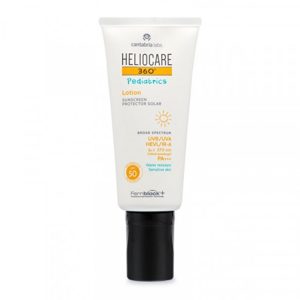 Heliocare - pediatrics atopic lotion sunscreen. A white bottle with a black screw cap and Heliocare branding.